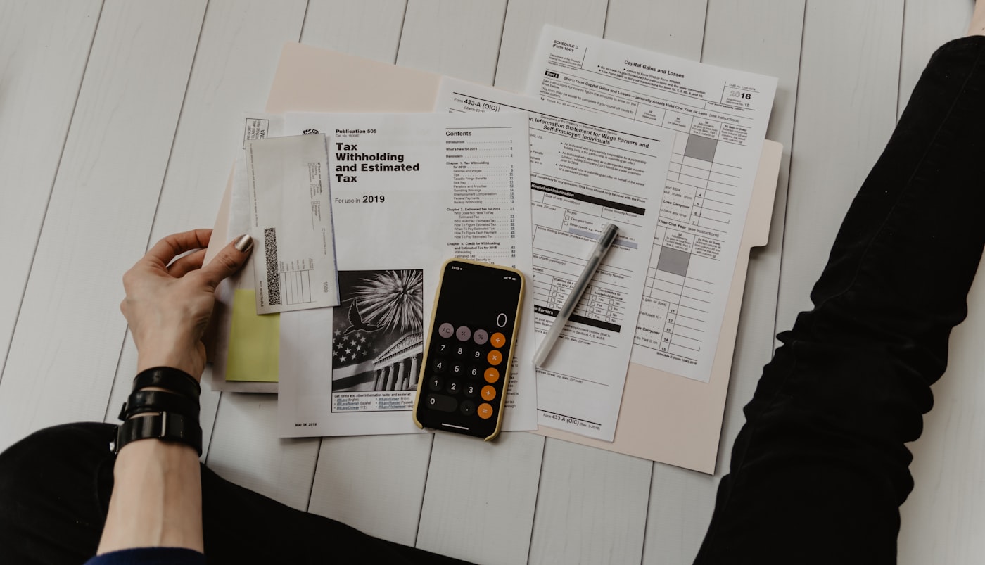 Calculator, receipt and notebook used to compare health program costs.