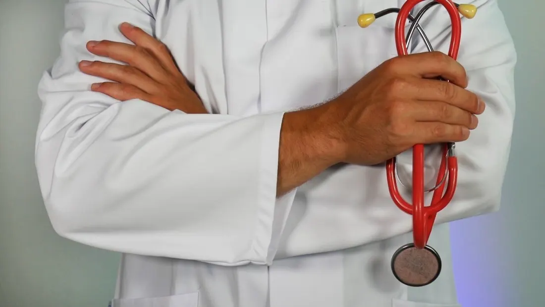 Clinician holding a stethoscope.