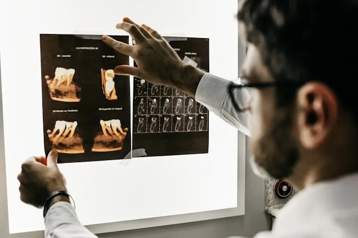 Clinician reviewing scans on a lightbox.