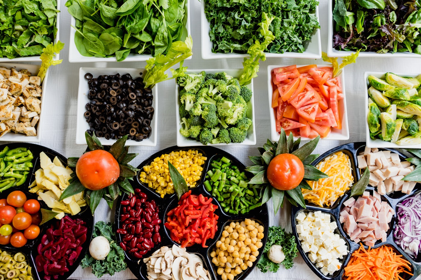 Hands preparing vegetables in a kitchen.