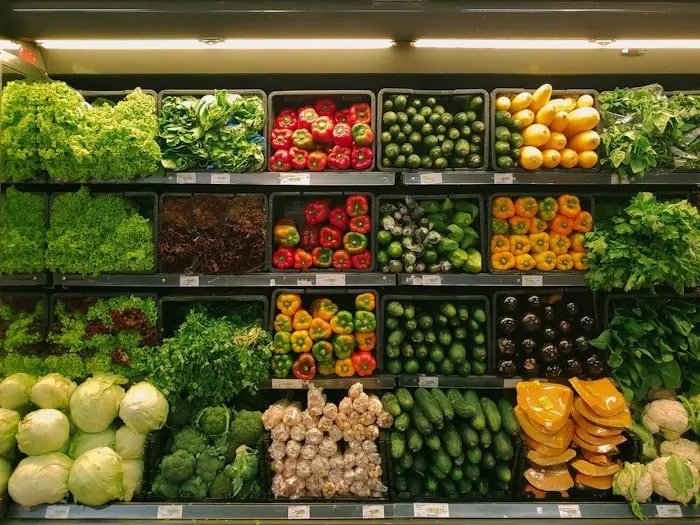 Stocked produce shelves in a grocery store.